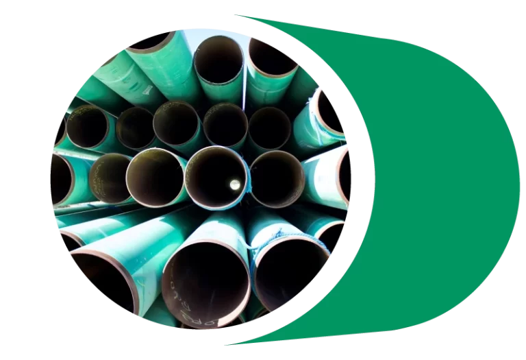 Large diameter pipes sit in storage.