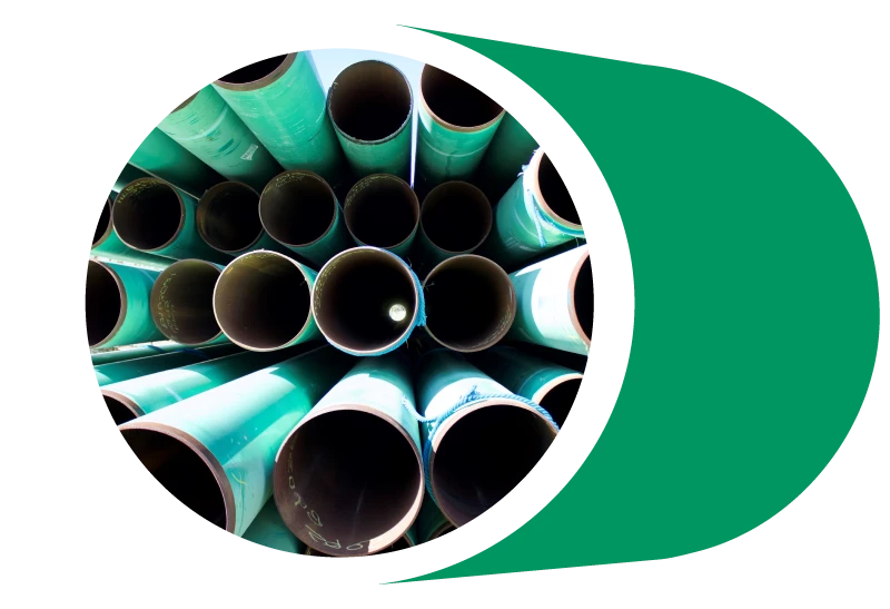 Large diameter pipes sit in storage.