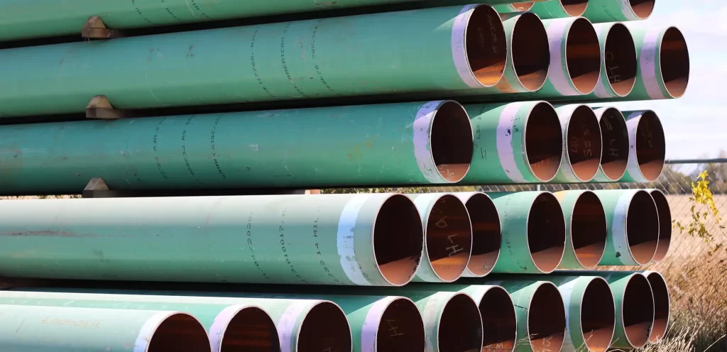 Various large diameter pipes in storage.